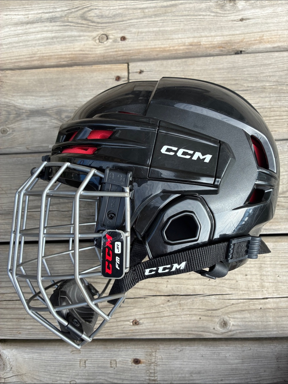 CCM Kids Black Hockey Helmet with Silver Cage and Red Accents